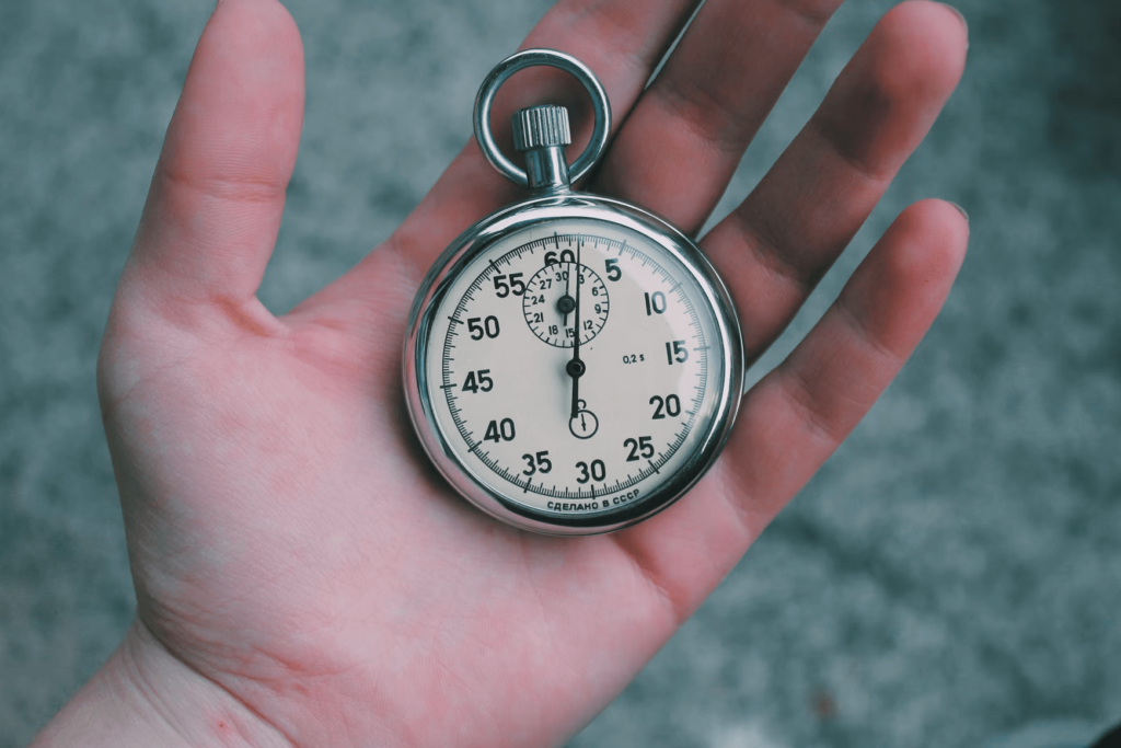 A man holding a stopwatch that can accurately measure time