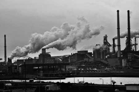 Image of the Industrial Revolution. Buildings with smoke coming out of them. Taken from Pexels